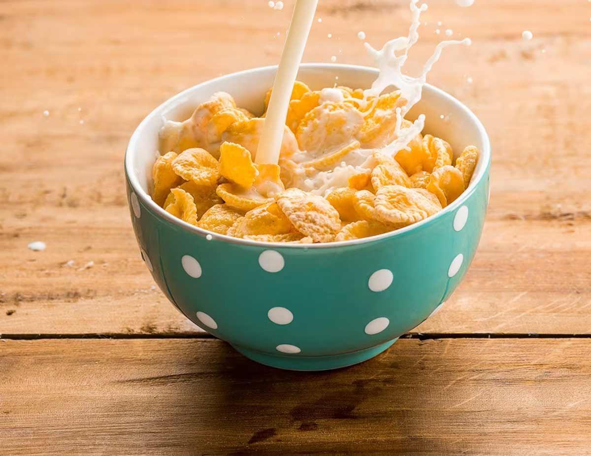 How was Corn Flakes, a popular American and Indian snack, made?