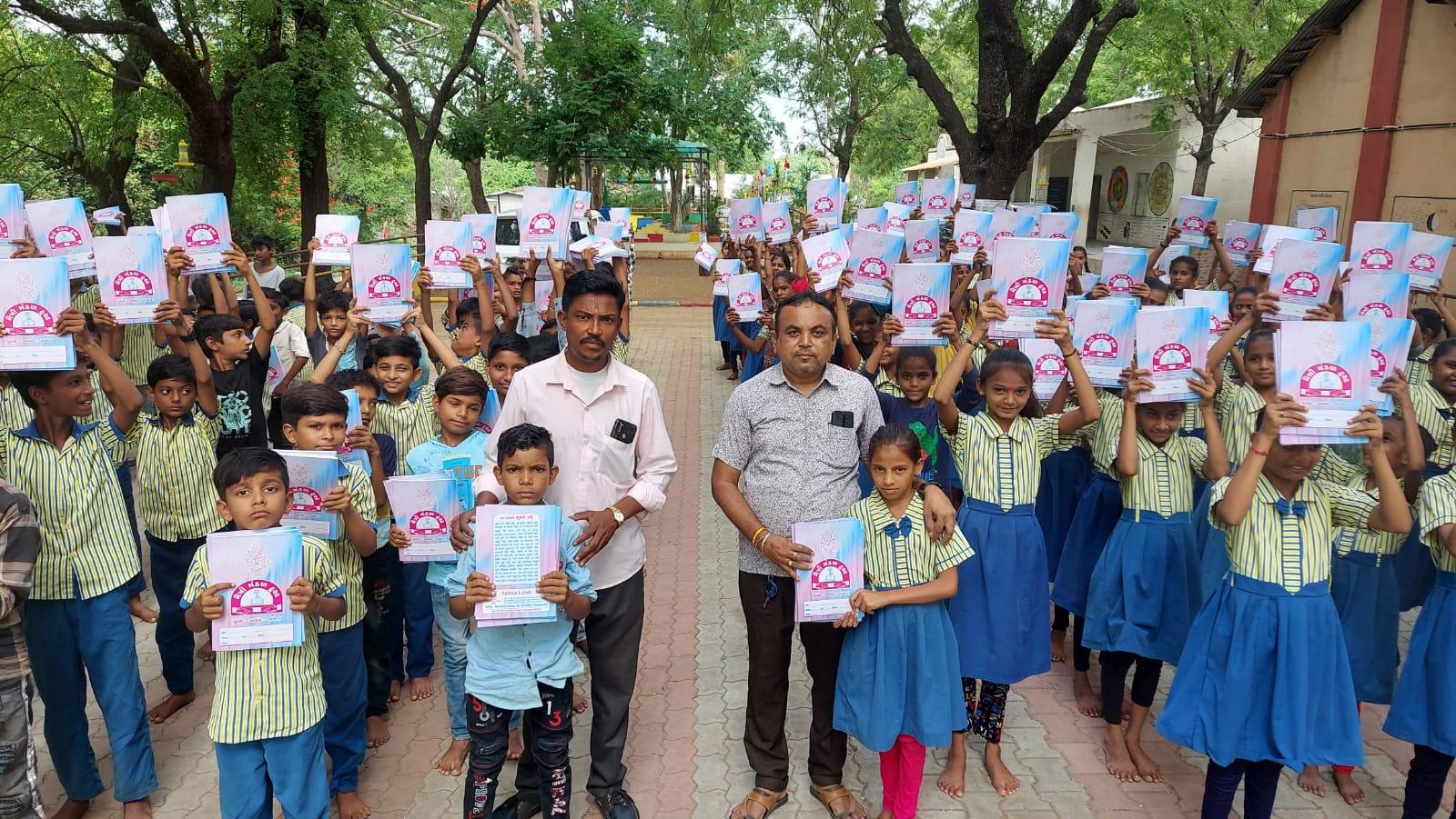 Distribution of free books to students by Maitri Mandal Trust at Bakrol Primary School