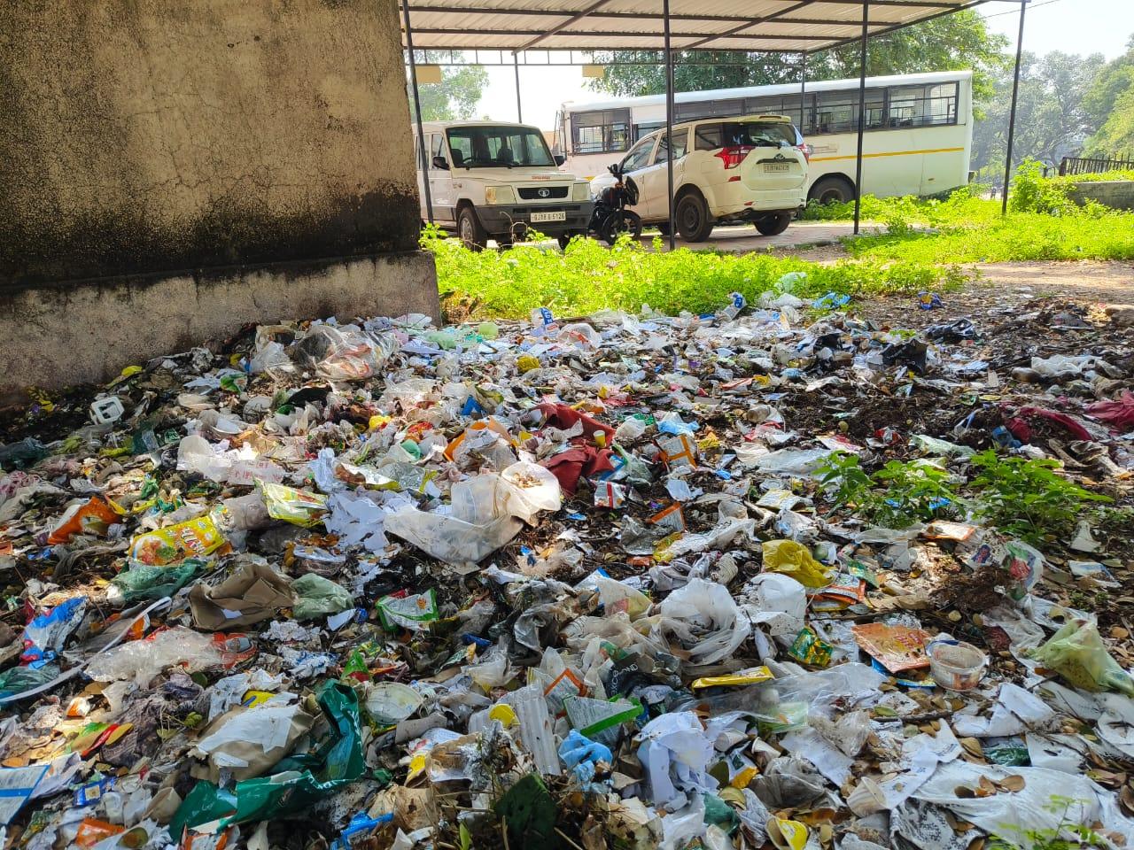 On one side the display of cleanliness campaign and on the other side the pile of garbage behind Chotaudepur Court.